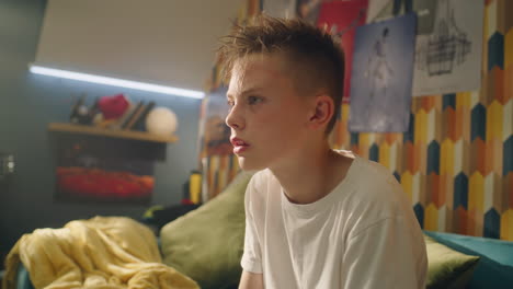 teenager sitting in a bedroom