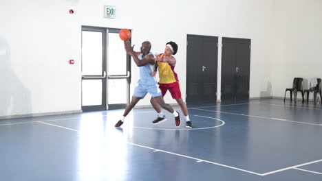 practicing dribbling skills, basketball players focused and determined on school court