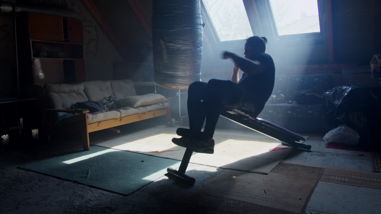 Man Working Out in an Attic Home Gym