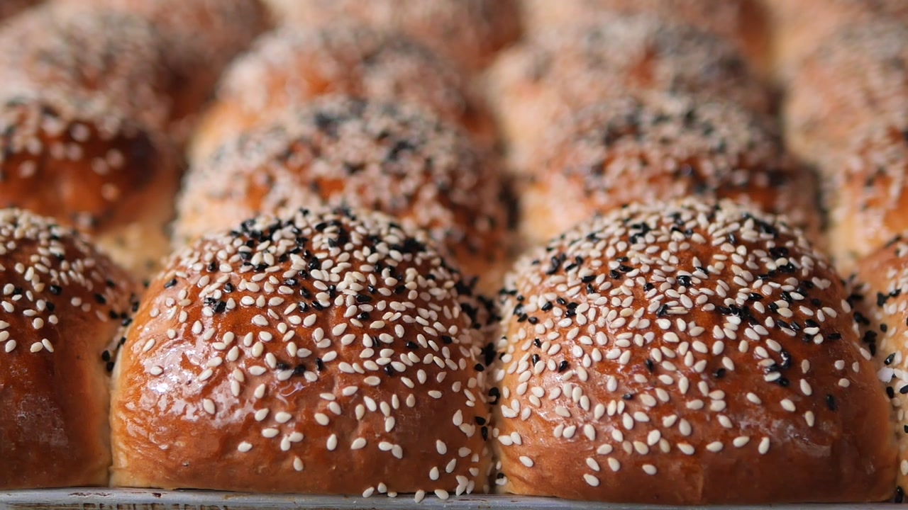 Freshly Baked Golden Brown Buns Topped with Sesame Seeds