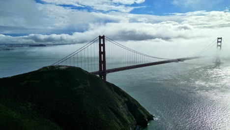 aerial drone panning view of golden gate bridge on a sunny foggy day