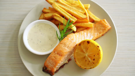 fried-salmon-fish-and-chips-with-lemon-on-plate