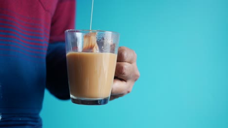 a person holding a cup of tea