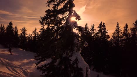 Snowy-mountains-in-low-clouds-and-blue-sky-at-sunset-in-winter