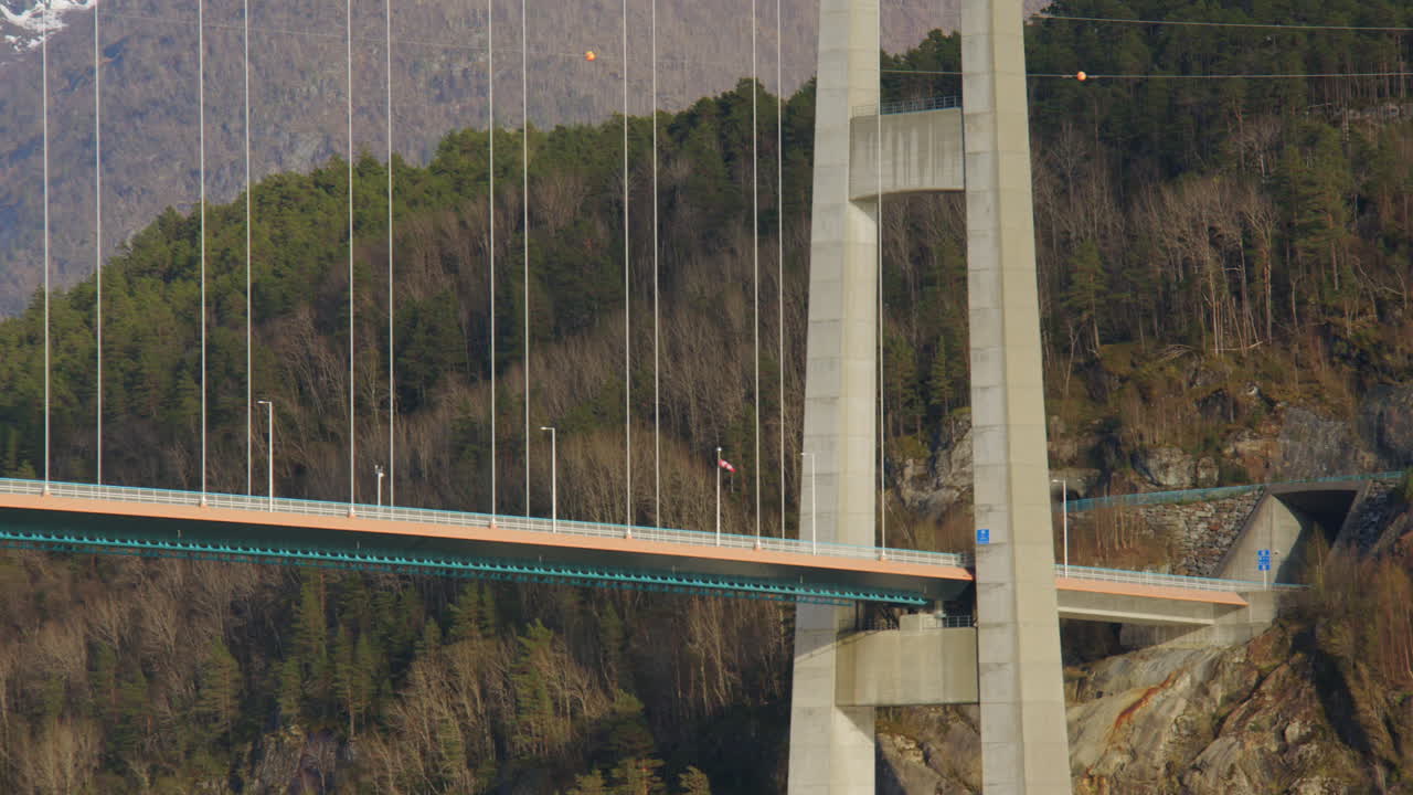Mid shot of sailing past the Hardanger bridge on the Eidfjorden, Eldfjord