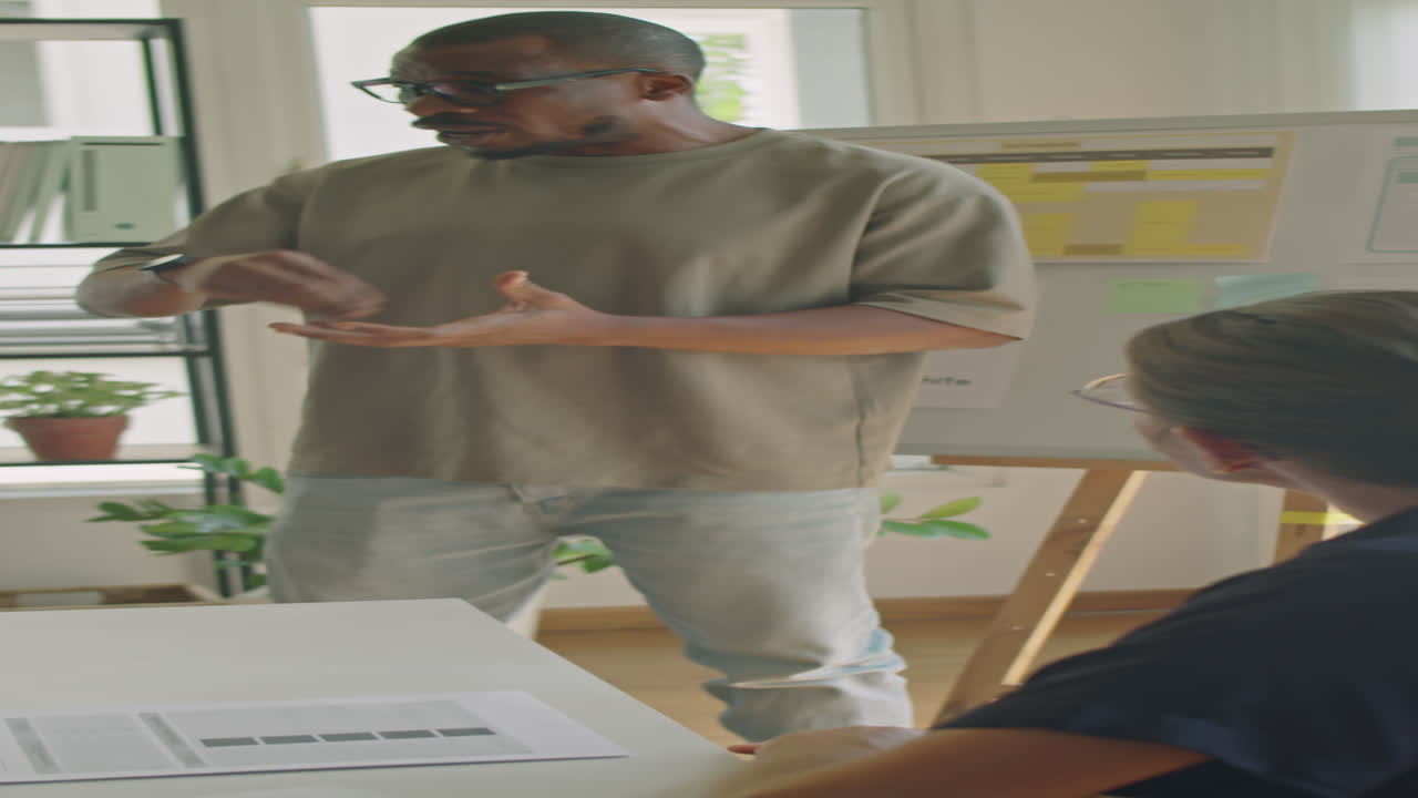 Black Man Giving Lesson by Whiteboard