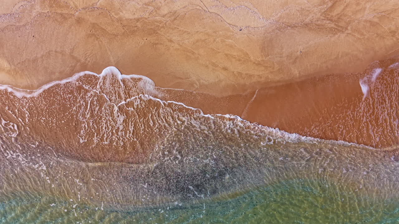 Endless waves dance upon the golden shore at sunset, creating a serene horizon where the sea meets the sky in tranquil beauty