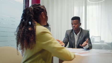 happy confident black woman recruit handshaking employer getting hired at new job. smiling young female professional manager shake hand of black man client or customer making business office meeting