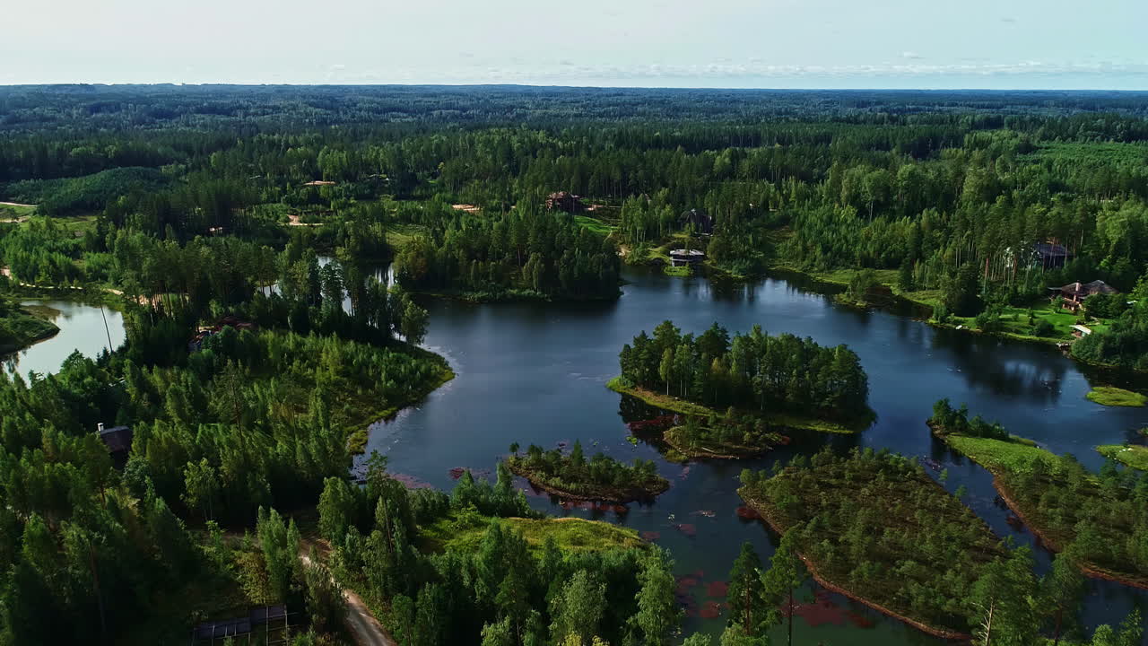 Luxury villas, lake with islands and woodland landscape of Latvia, aerial view