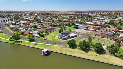 Over-a-tourist-boat-moored-on-the-shore-of-Lake-Mulwala-with-the-town-of-Yarrawonga-and-farmland-beyond