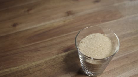 Medium-close-shot-of-brown-sugar-sitting-in-a-small-glass-jar