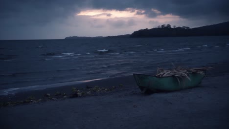 a boat on the beach during sunrise on