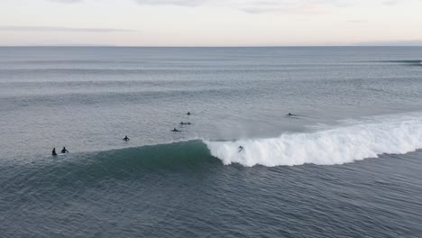 Surfer-dropping-in-from-lineup-gets-caught-in-whitewash-from-wave,-aerial