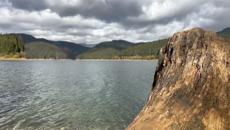 clouded sky rolling over bolboci lake during sunny day in central romania