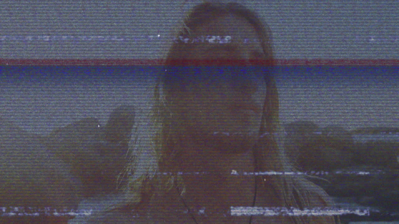 Animation of person with long hair, glitchy horizontal lines creating distortion