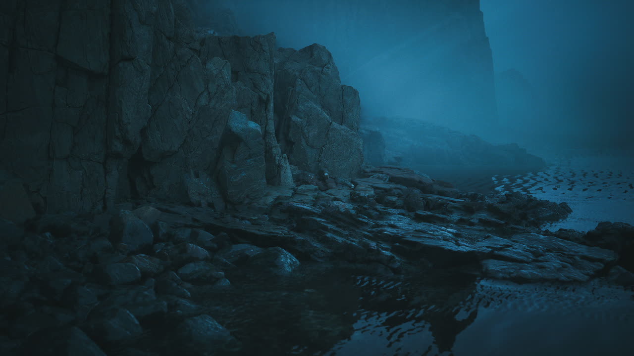 Foggy coastline with rocky formations and tranquil water at dusk