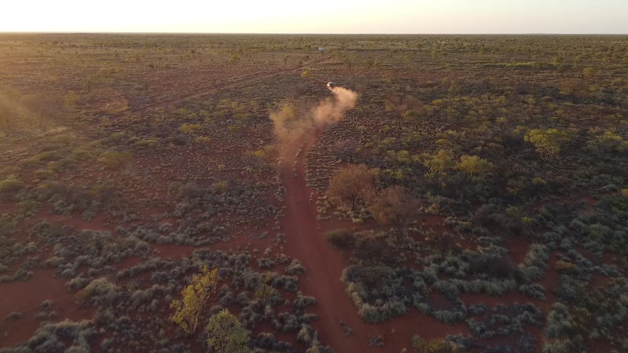 4 드라이브 차량 은 해 가 지는 동안 오스트레일리아 의 외 지역 에 있는 먼지 가 가득 한 사막 도로 를 따라 이동 한다