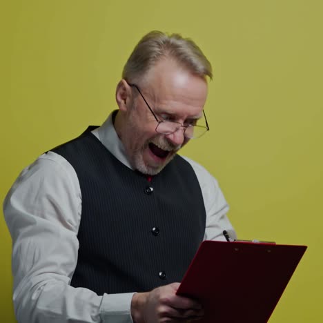 thoughtful old businessman with a folder. mature man becomes happy after finding the right solution to his project. positive emotions.