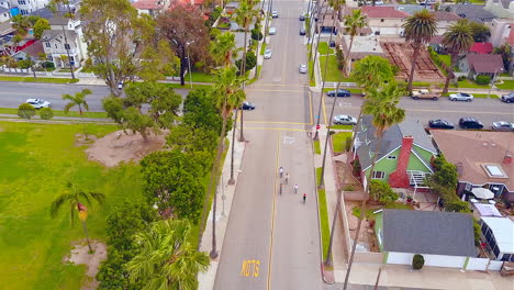 drone footage of 5 people riding their bikes through a neighborhood