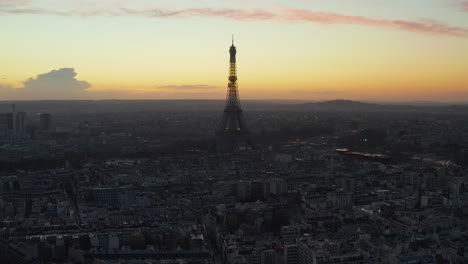 Breath-taking-silhouette-of-amazing-structure-of-Eiffel-Tower-against-colourful-sunset-sky.-Aerial-descending-footage-of-cityscape-at-dusk.-Paris,-France