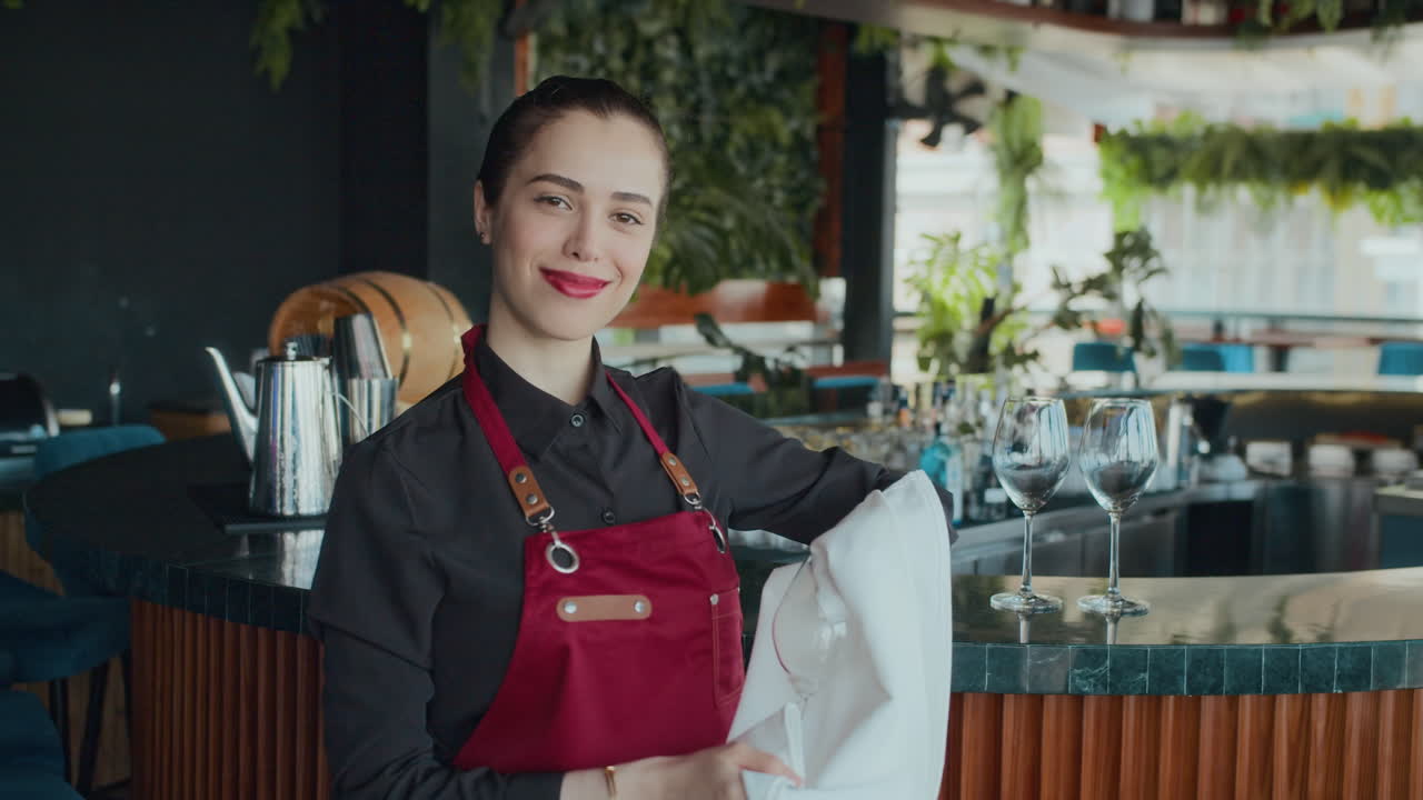 Caucasian Waitress Looking at Camera near Bar at Cafe