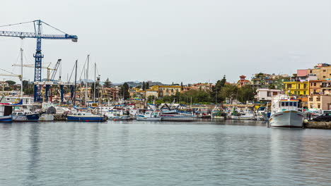 View-of-the-boats-docked-in-port-of-Bagnera-in-the-locality-of-Porticello-near-Palermo-in-Sicily,-Italy-at-daytime-in-timelapse