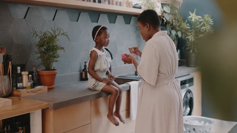 Black-family,-mother-and-girl-feeding