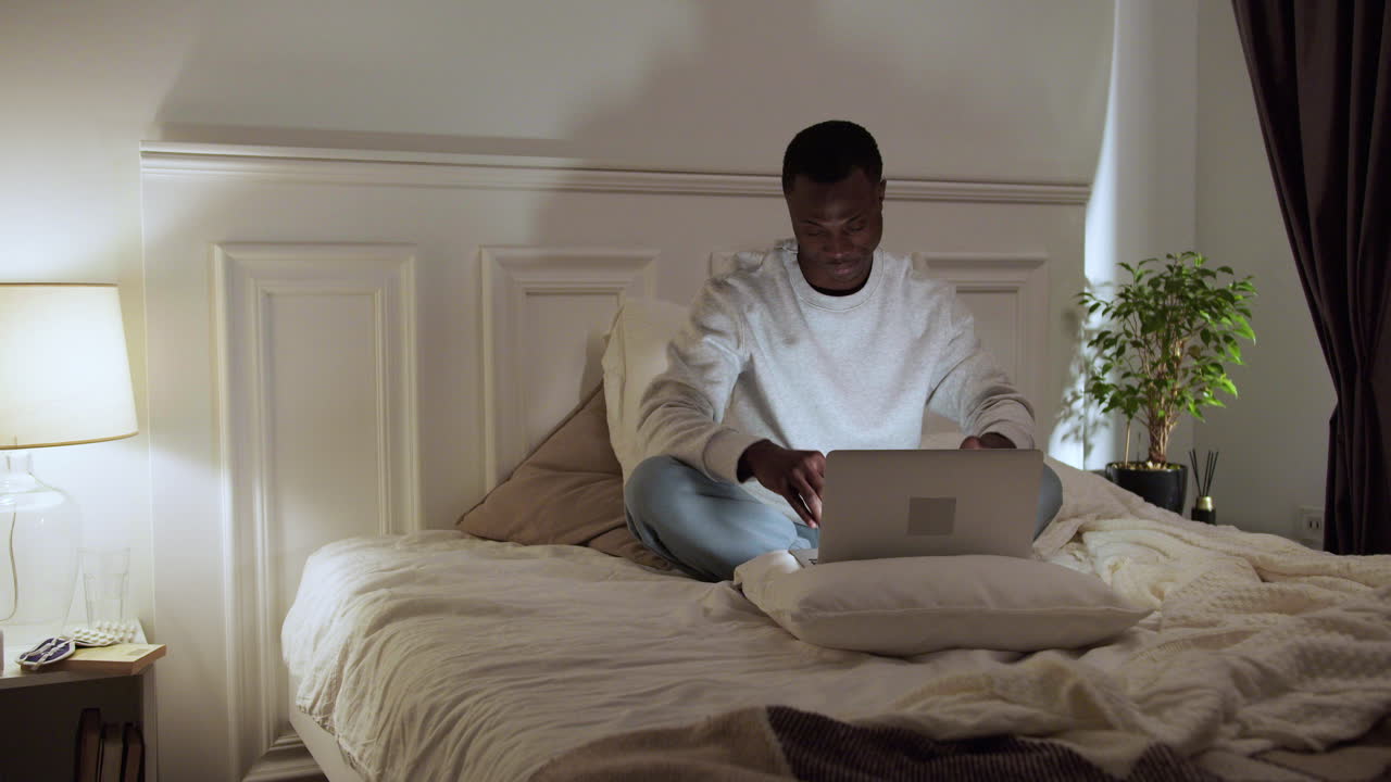 Young tired man on bed