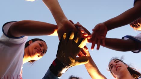 Low-angle-view-of-diverse-female-soccer-team-clasping-hands-4k