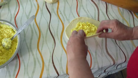 woman models the dough filled with cheese