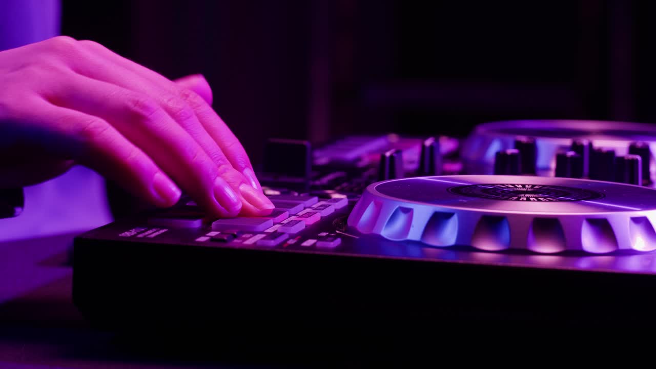 DJ with headphones and sunglasses playing music on festival in night club. Techno musician performing at nightclub for concert crowd of people, city bar.