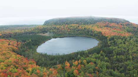 spectacular orbiting aerial view of oberg lake and mountain