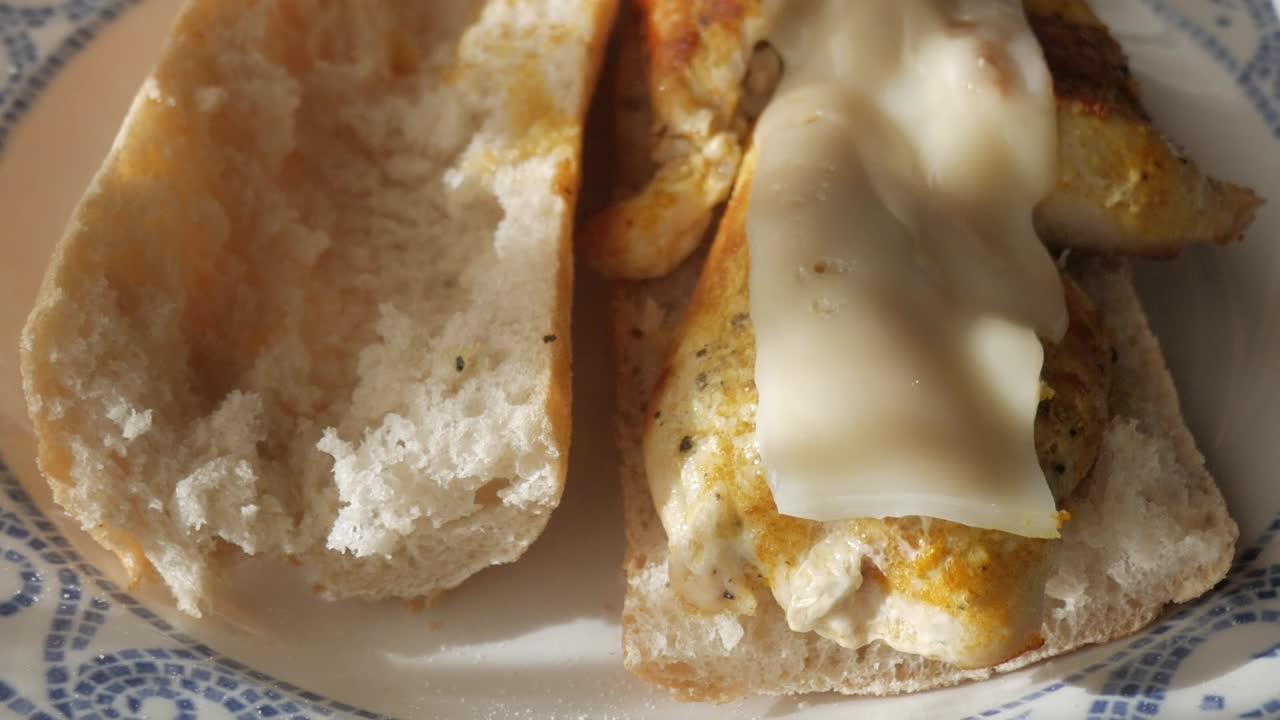 Juicy chicken with melted cheese in a crusty baguette, homemade sandwich delight