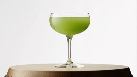 green beverage in a stemmed glass