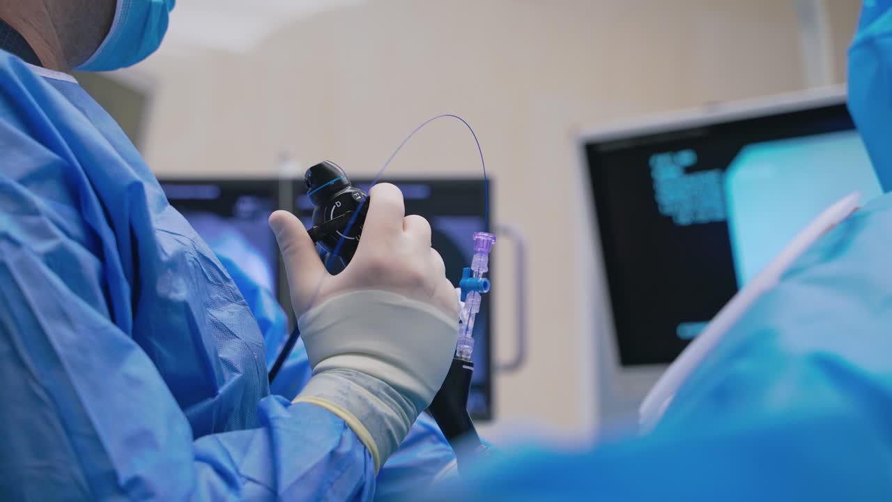 New technologies in surgery. Close-up doctor's hand with modern equipment during the operating process on monitors background. Medical concept.