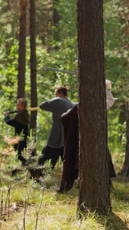 commander trains soldiers sword fighting in sunny pine wood slow motion. event of historical reenactment club. reconstruction of amazing medieval period