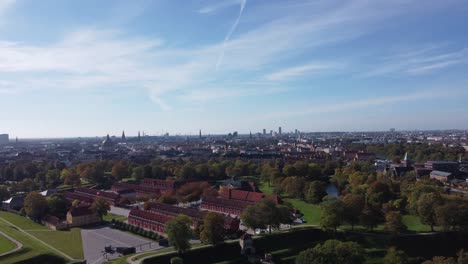 splendid kastellet fortress with its perimeter wall and moat besides the red houses and leafy trees on a summer day in copenhagen, aerial view