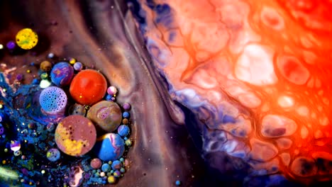 abstract colorful acrylic and food paint bubbles on water