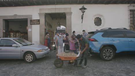 slow movement forward showing a man selling peanuts out of a wheelbarrow