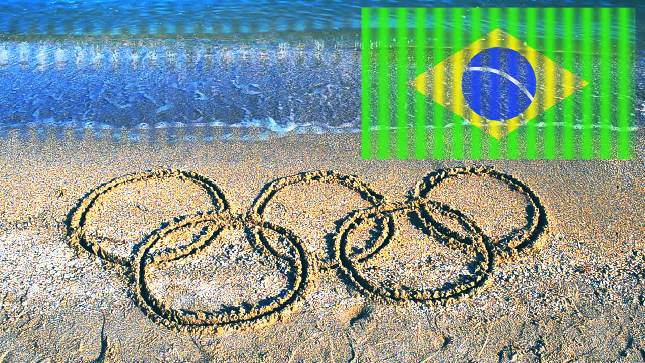 Olympisk symbol i sandet på stranden. Indskrift på sand