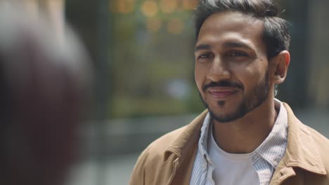 close up of muslim couple on date meeting and talking on city street together 2