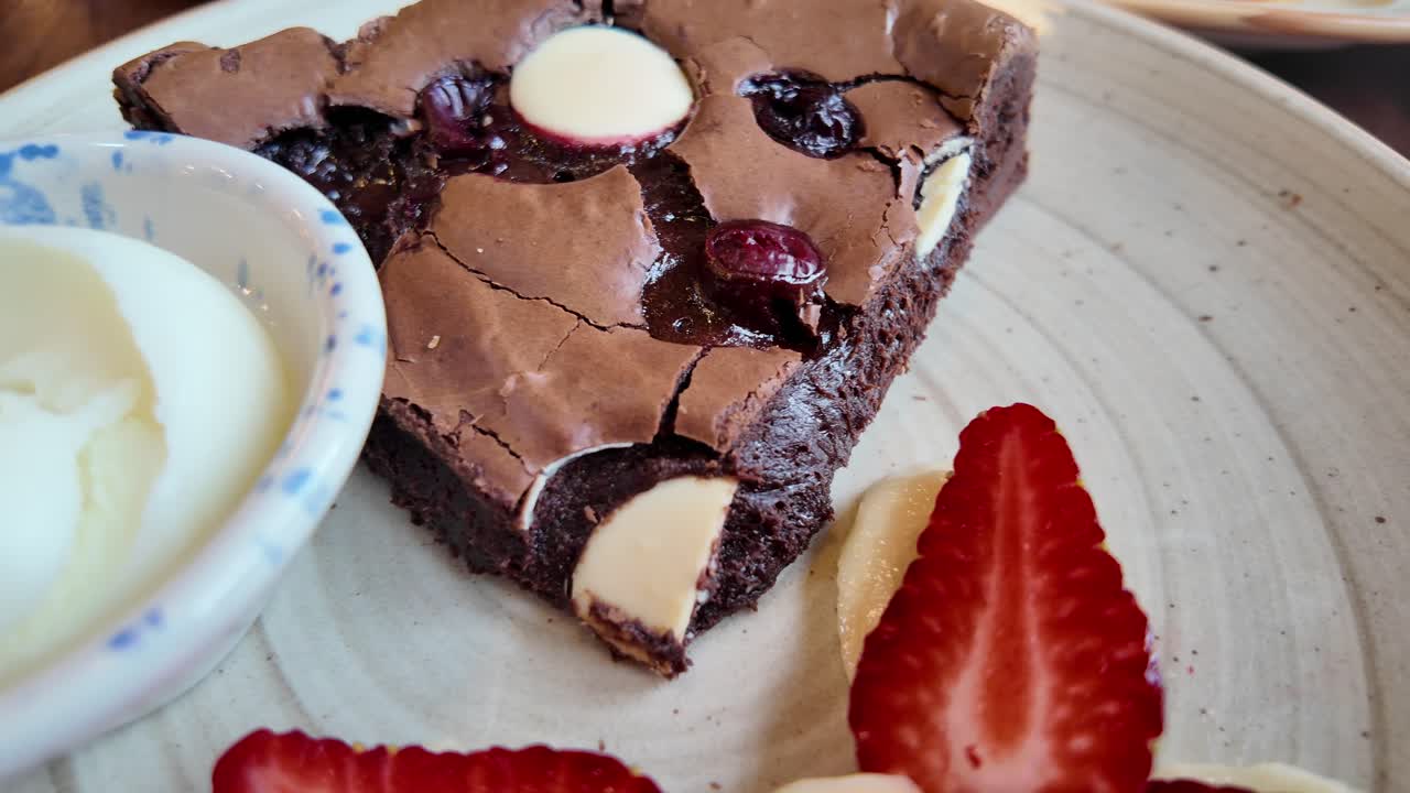 Delicious brownie with ice cream and strawberries
