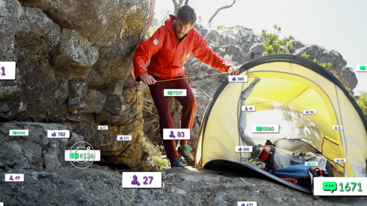 Man securing yellow tent line beside boulder, displaying floating social media marketing icons