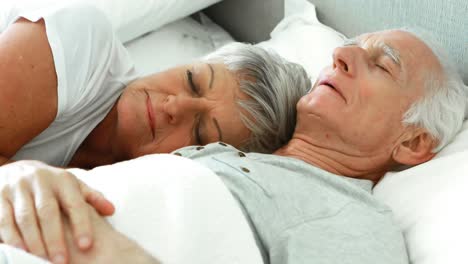 Senior-couple-sleeping-in-the-bedroom