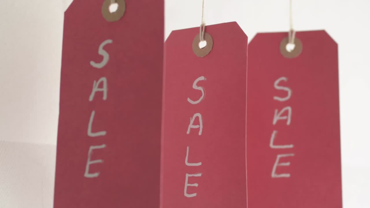 Red sale card signs hanging on display