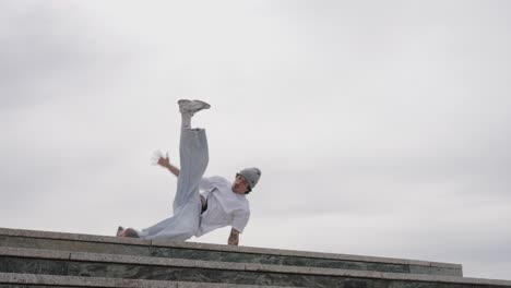 breakdancer performing acrobatics on urban rooftop