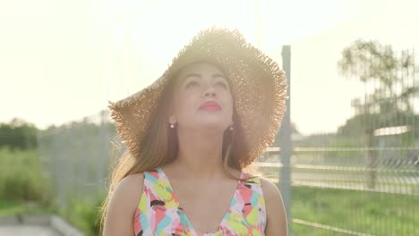 pregnant girl walks in a beautiful dress and hat