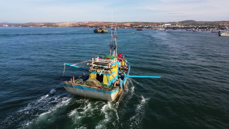 Following-a-fisherman's-boat-in-Mui-Ne,-Vietnam