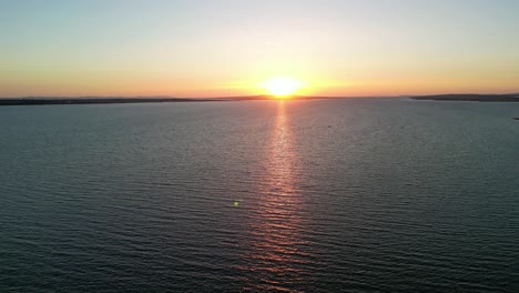 Beautiful-sunset-from-above-with-horizon-and-calm-Adriatic-Sea-and-turn-over-wild-and-protected-pine-forest-with-distant-Velebit-Mountain-View-in-Vrsi,-Zadar-county