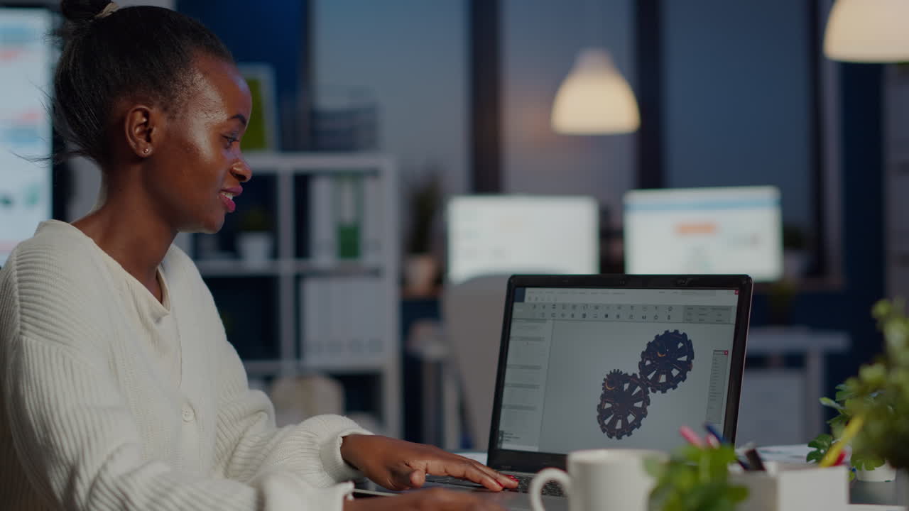 Black woman architect working in modern cad program at laptop